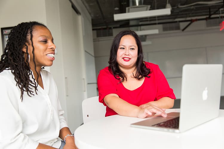 Canva - Woman Wearing Red Top Holding Silver Macbook (1)