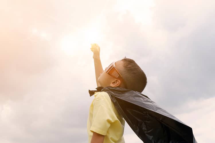 happy kid play superhero , boy power concept